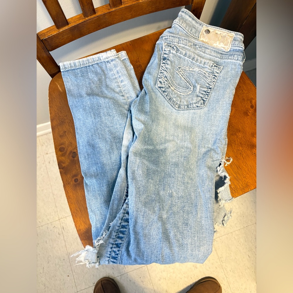 Women's Light Blue Silver jeans distressed with lace.